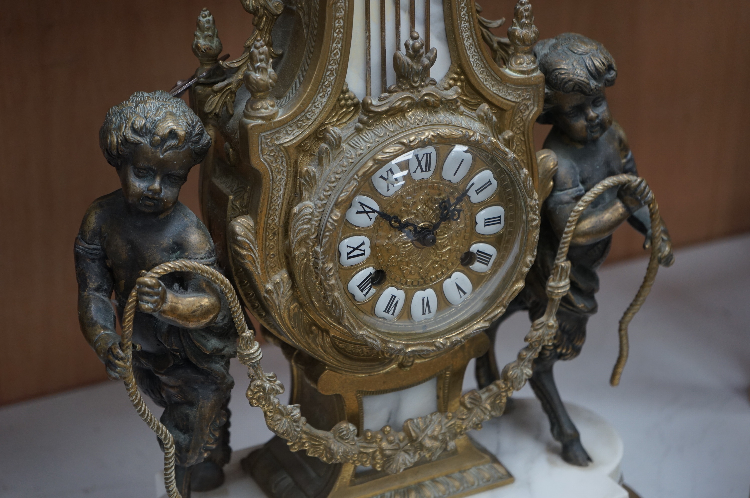 A gilt metal and marble clock garniture, with key, 61cm. Condition - fair/good